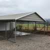 a clay and white squared frame horizontal roof carport with the front gable closed