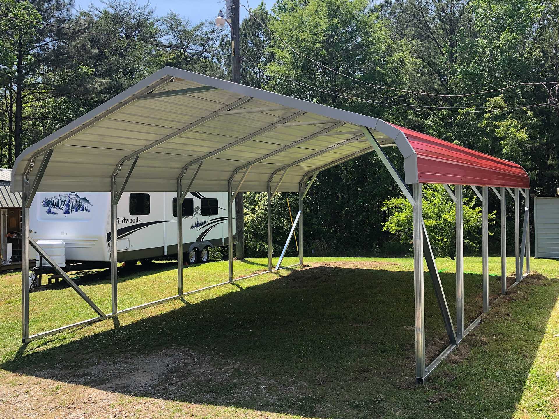 Rounded frame carport with red roof on green grass